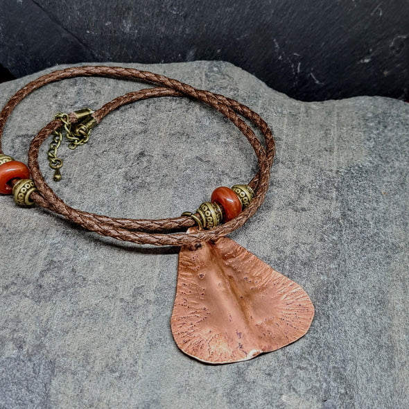 Showing rear of enamelled copper pear pendant