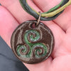 Ceramic triskele pendant to show size