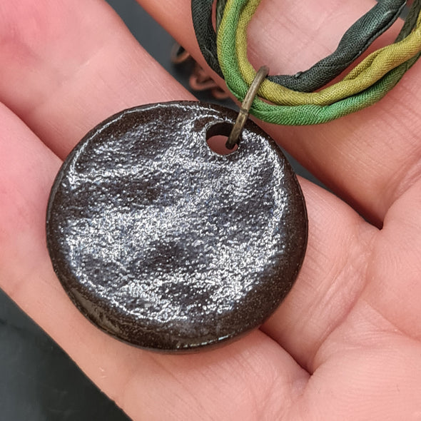 Rear view of ceramic triskele pendant