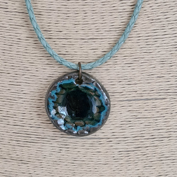 Circular ceramic and glass pendant necklace