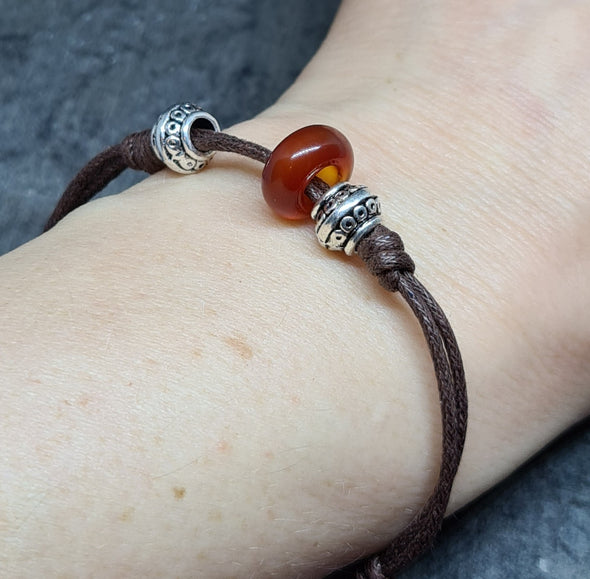 Red agate knot bracelet shown on wrist